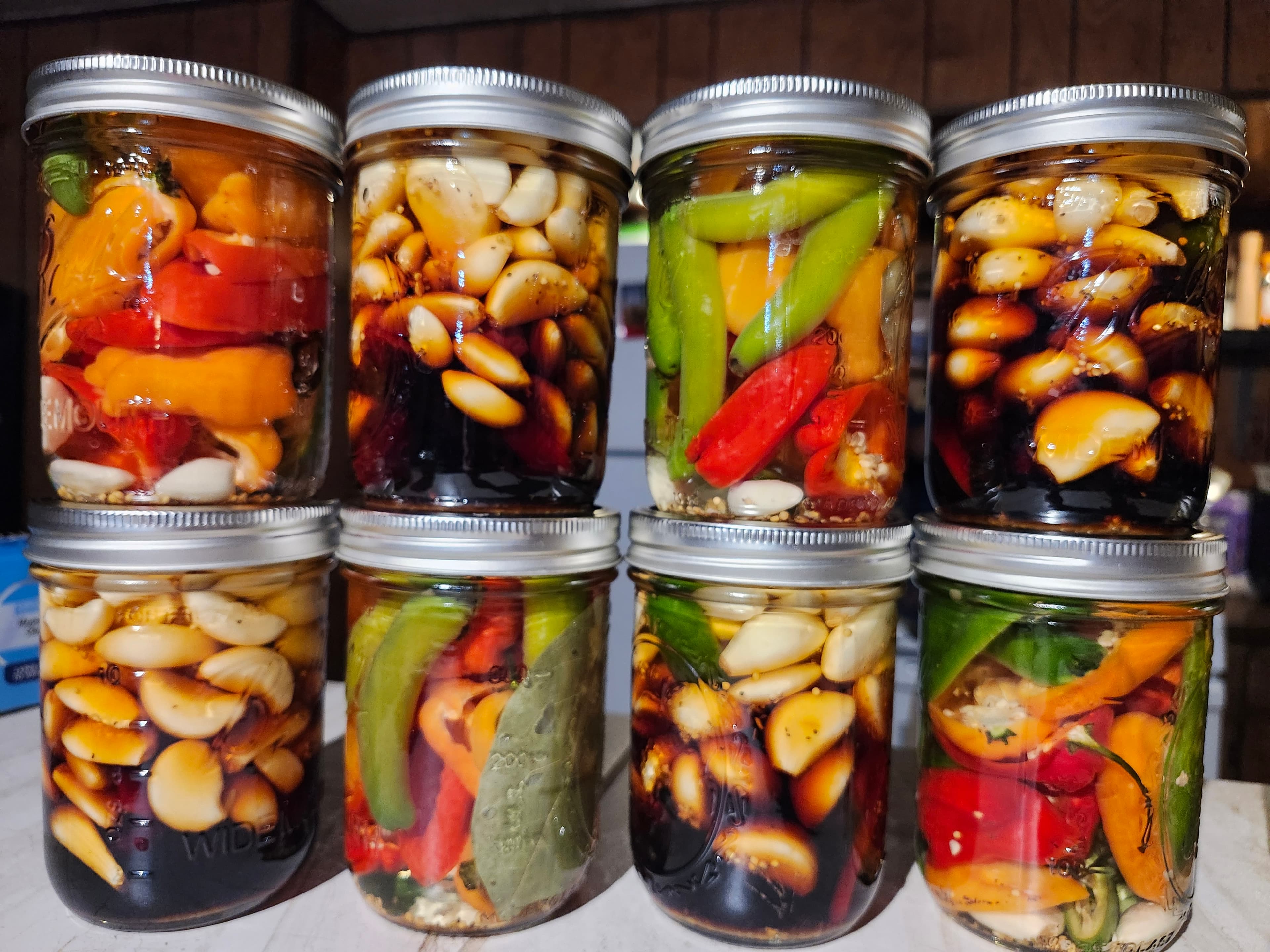 Colorful lineup of pepper and garlic jars
