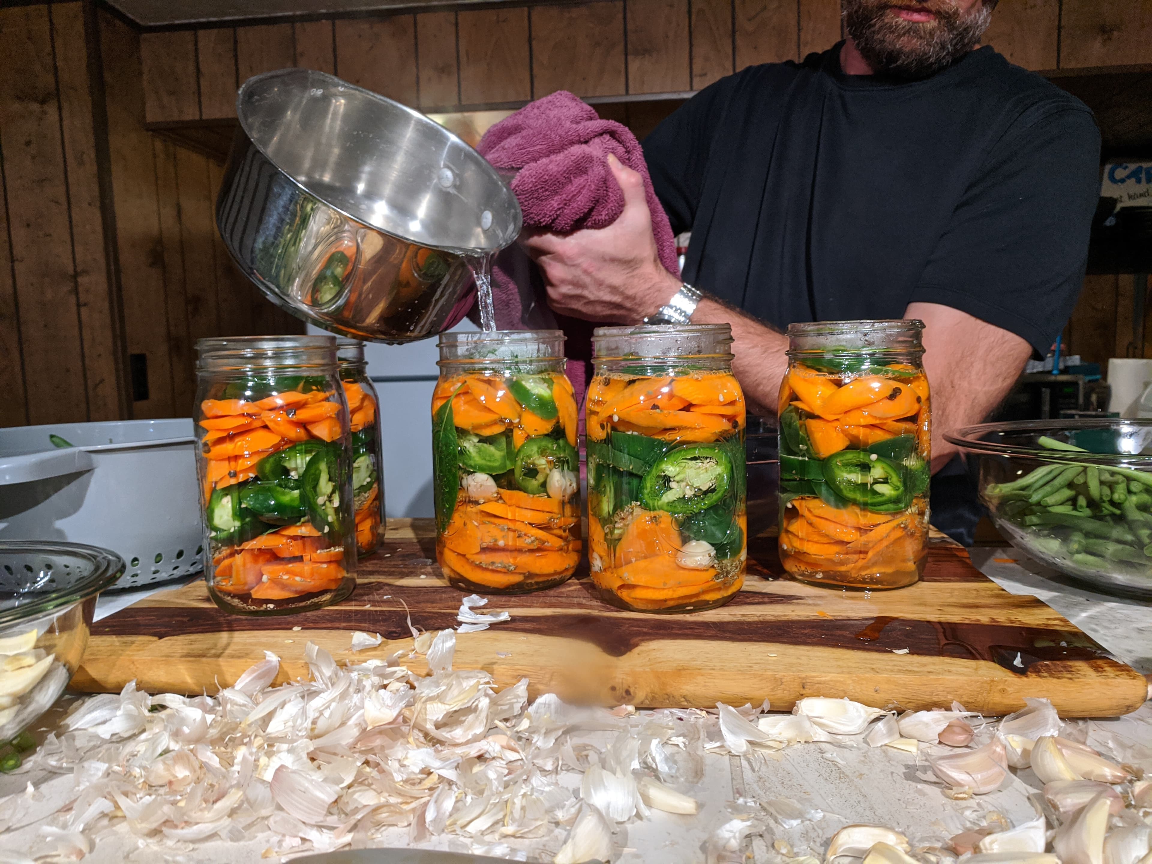 Pouring hot brine over fresh escabeche