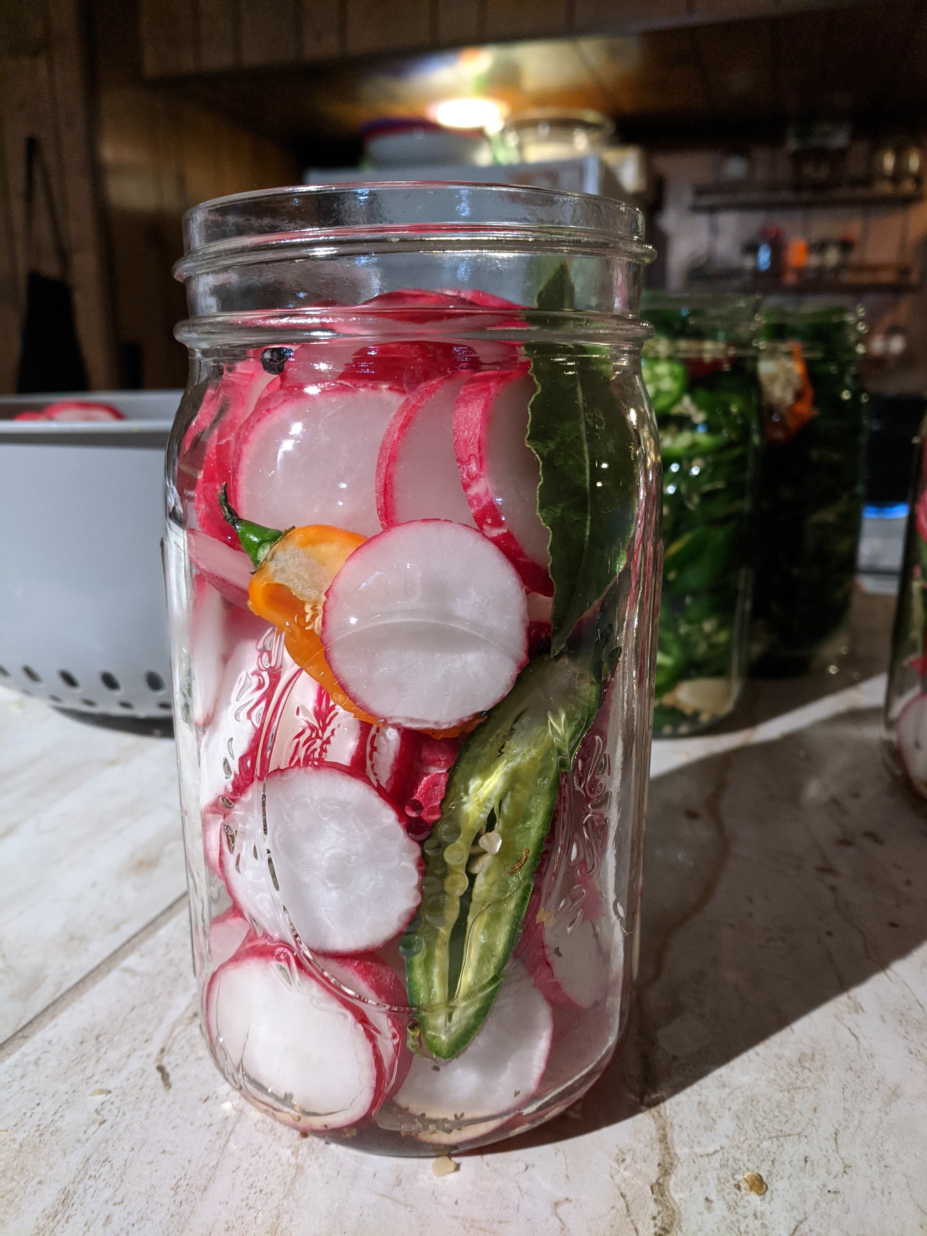 Fresh radish slices with peppers before sealing